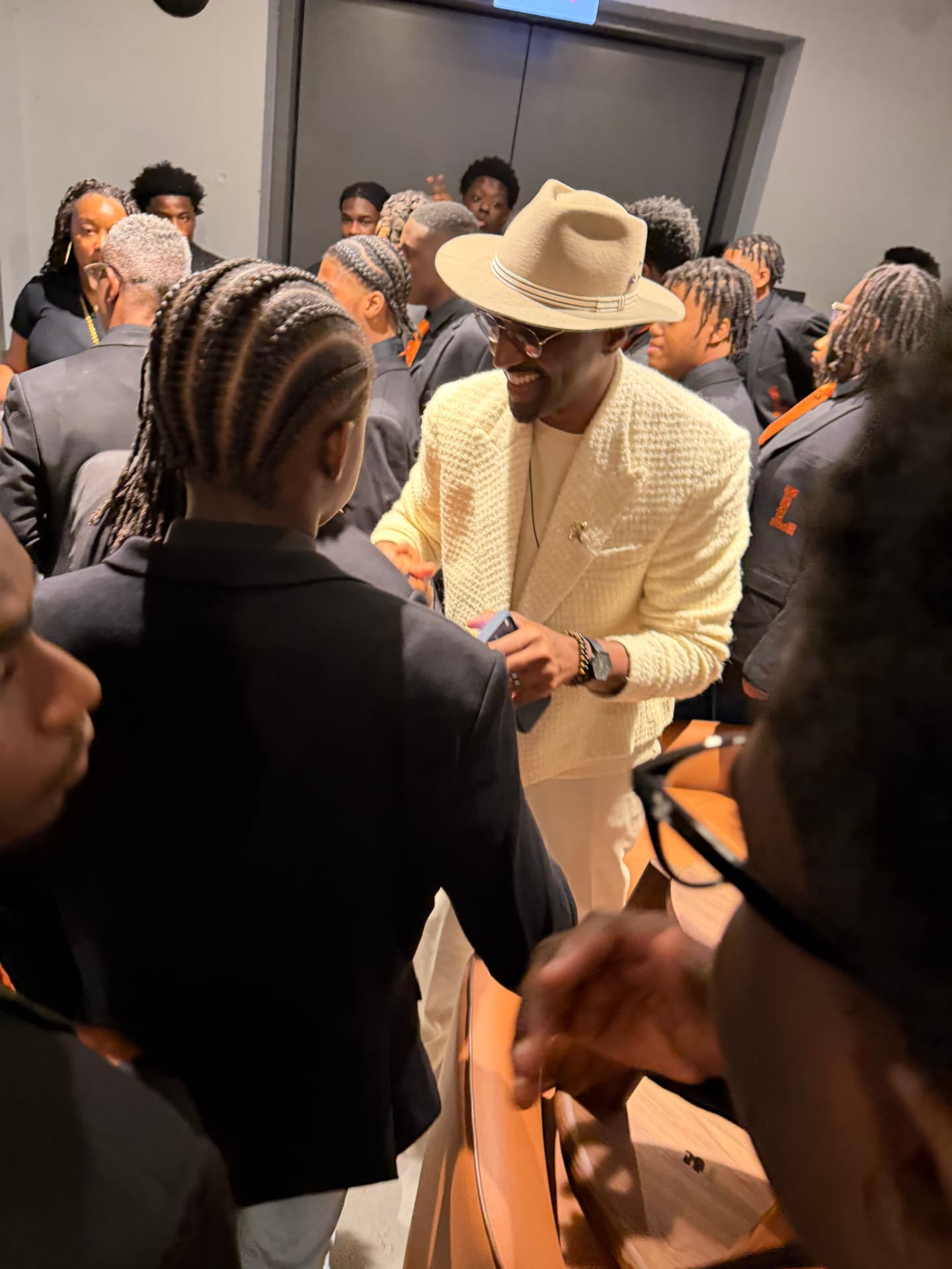 The guest artist smiling as he greets choir members backstage
