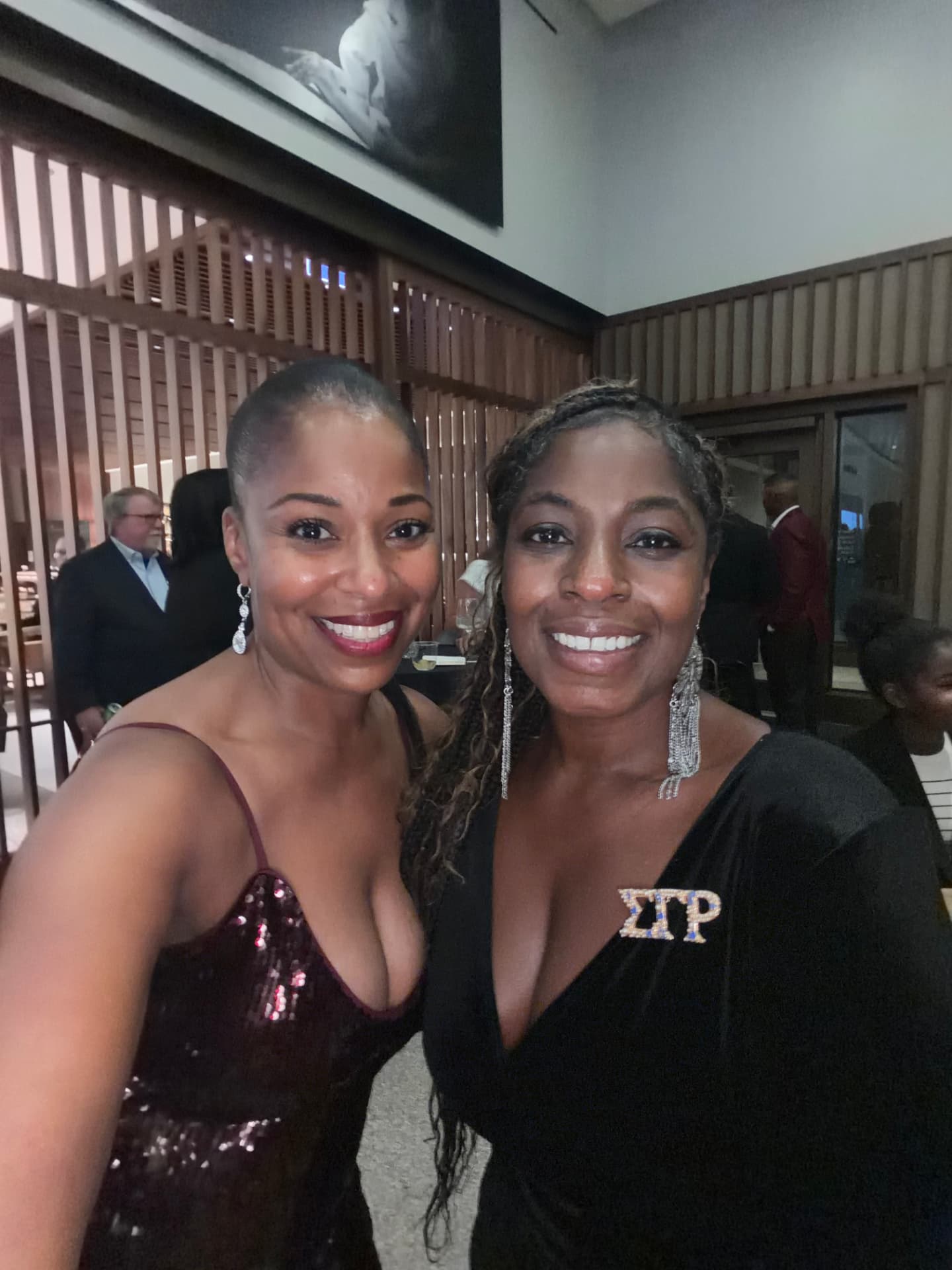 Two guests smiling together in a selfie at the reception