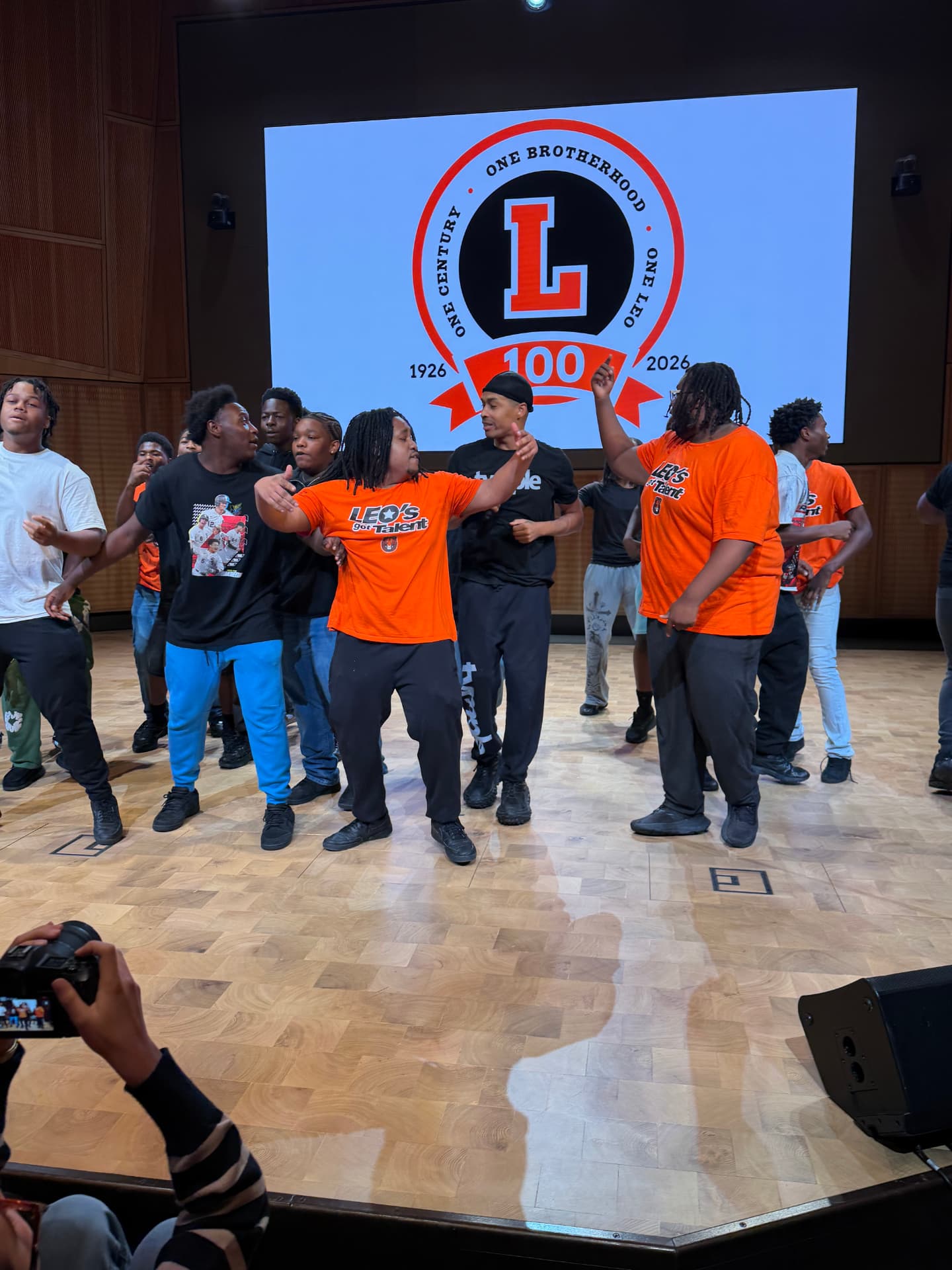 Choir members in Leo's Got Talent shirts dancing during rehearsal