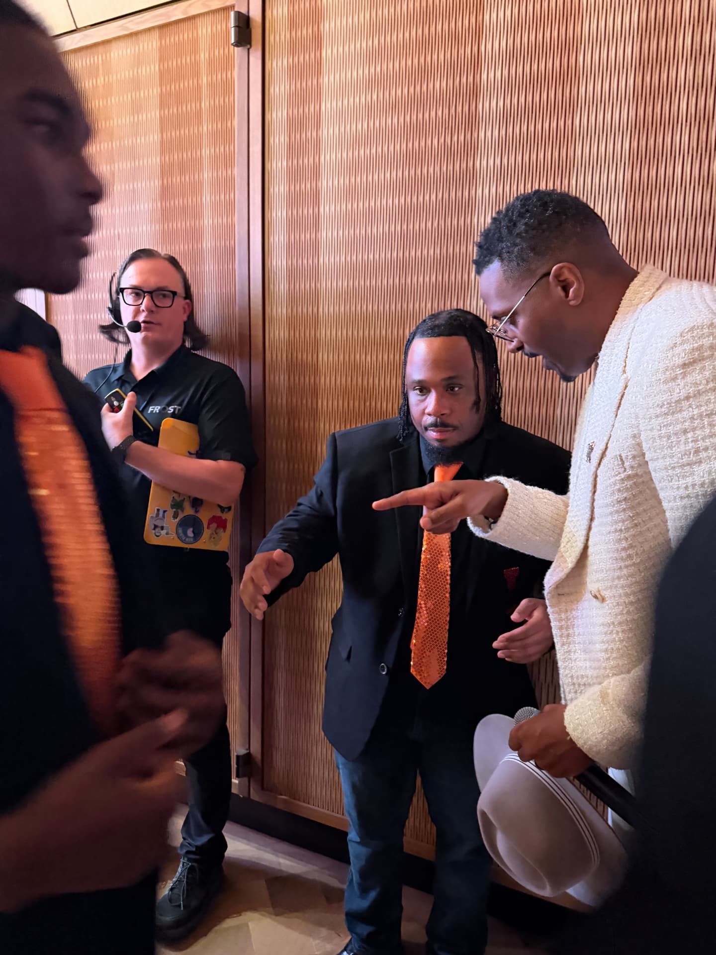 The guest artist giving direction to a choir leader before the performance