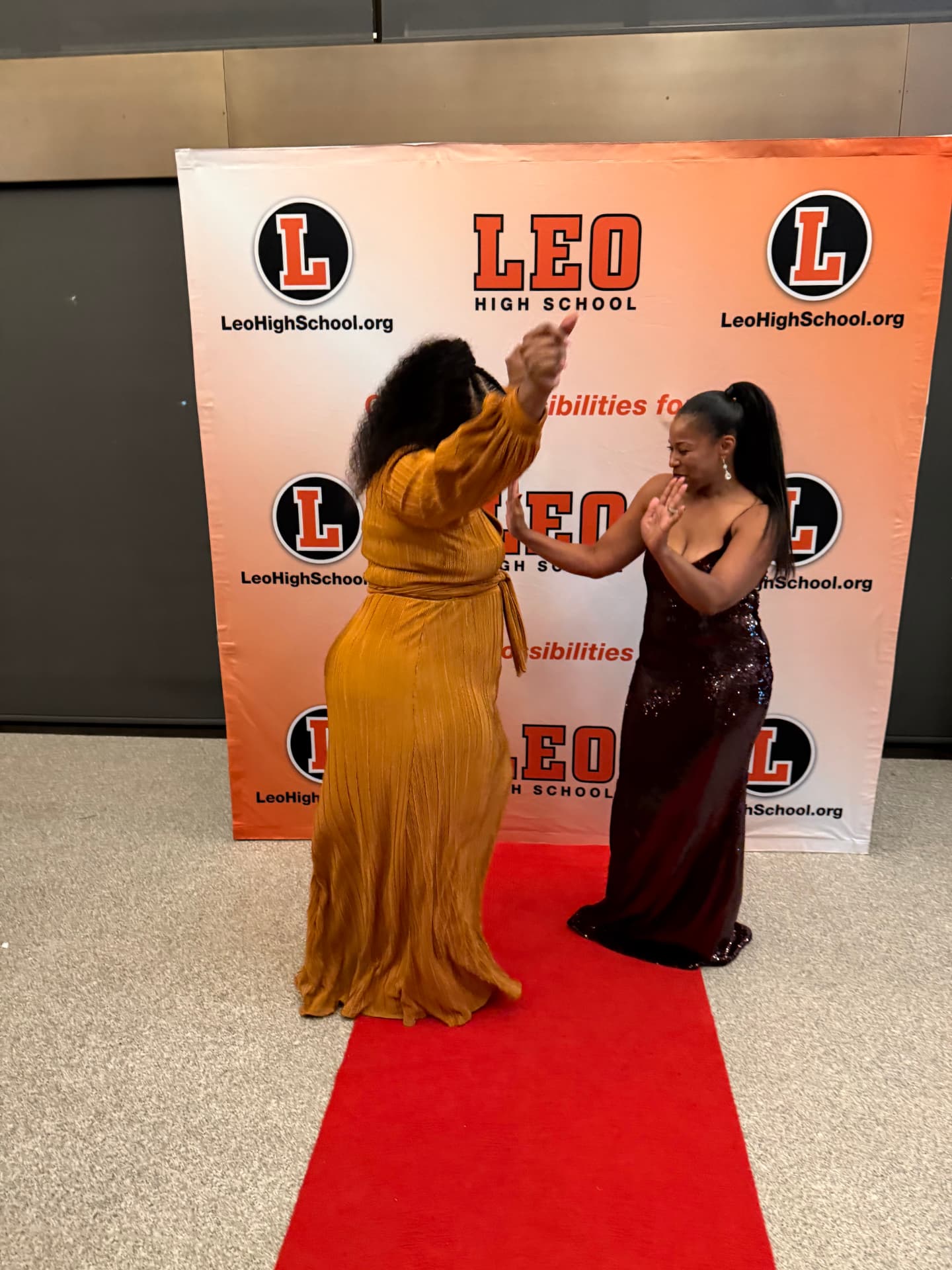 Two guests dancing together on the red carpet