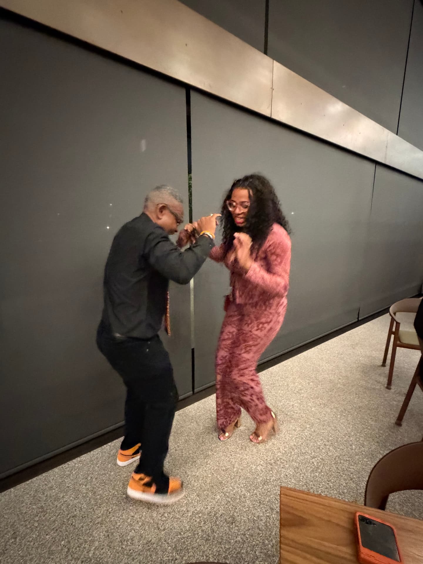 Two guests dancing together at the reception