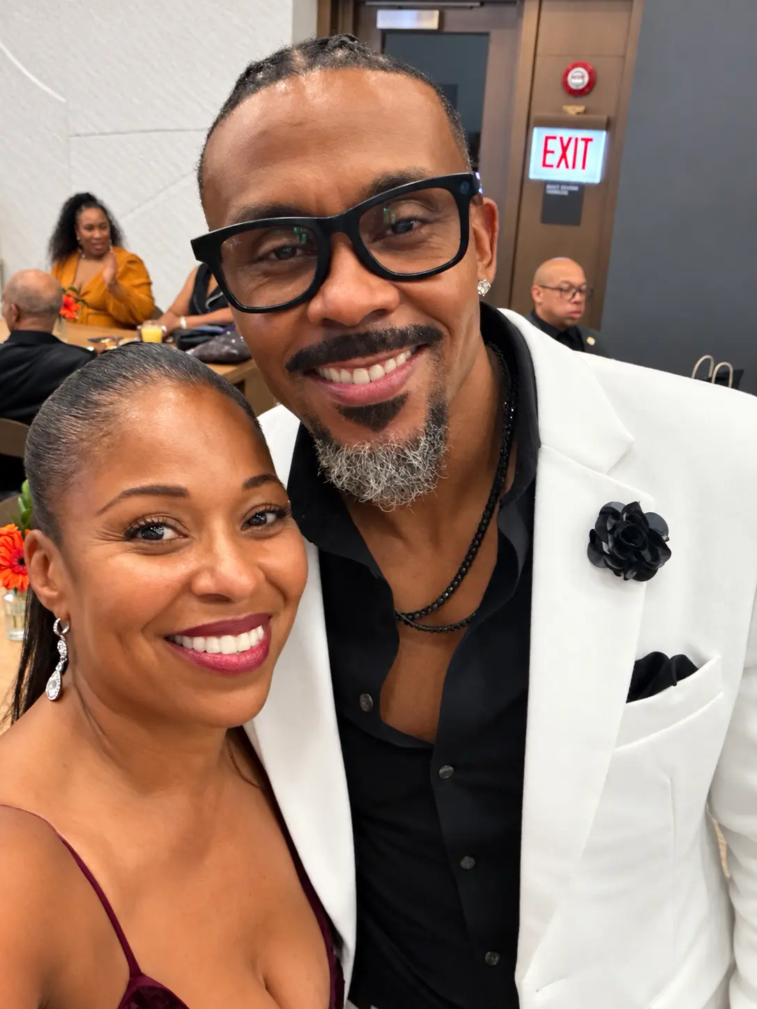 Two guests smiling together at the celebration