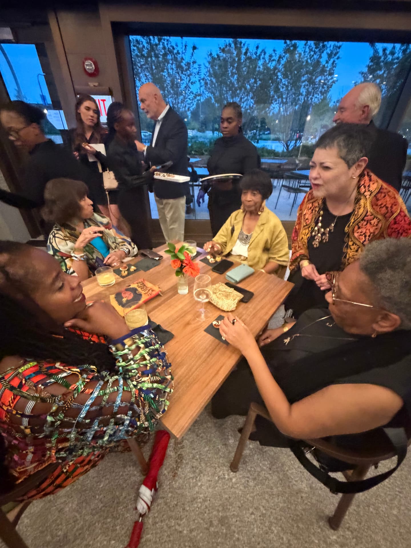 Guests talking around a table at the reception