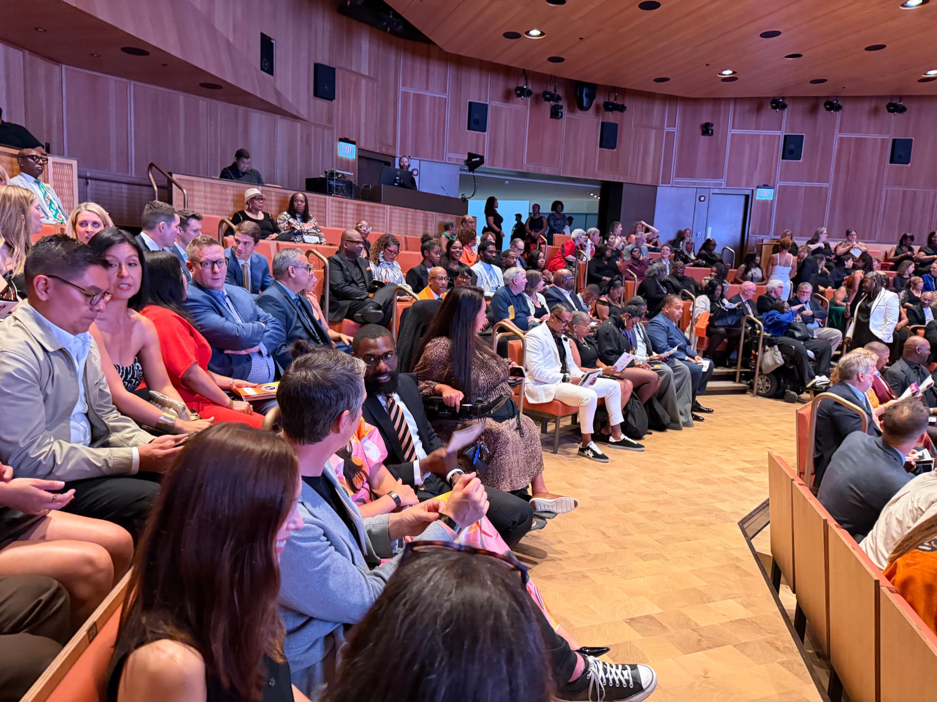 Guests filling the orange seats of the auditorium before the show