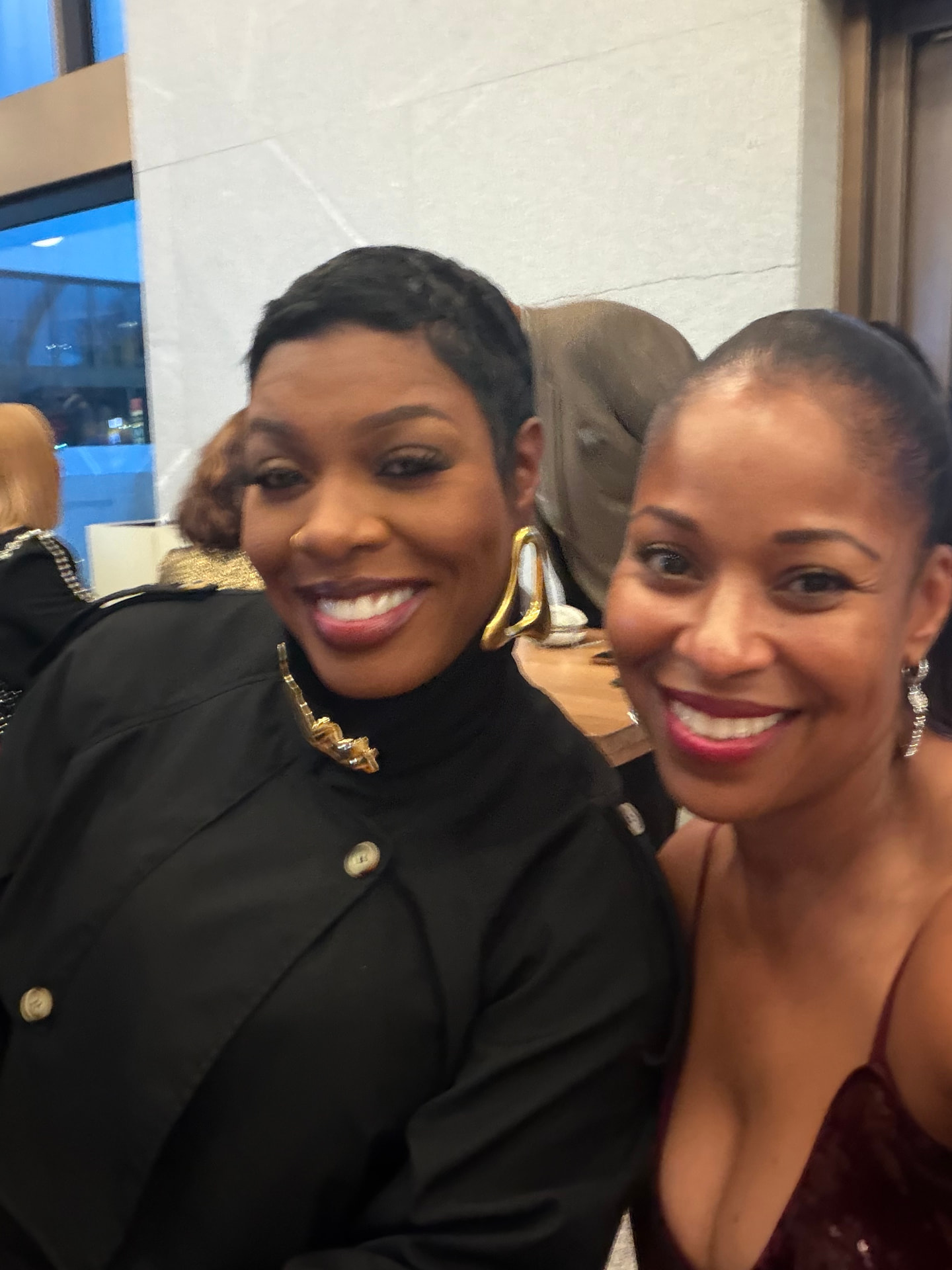 Two guests smiling together at the reception