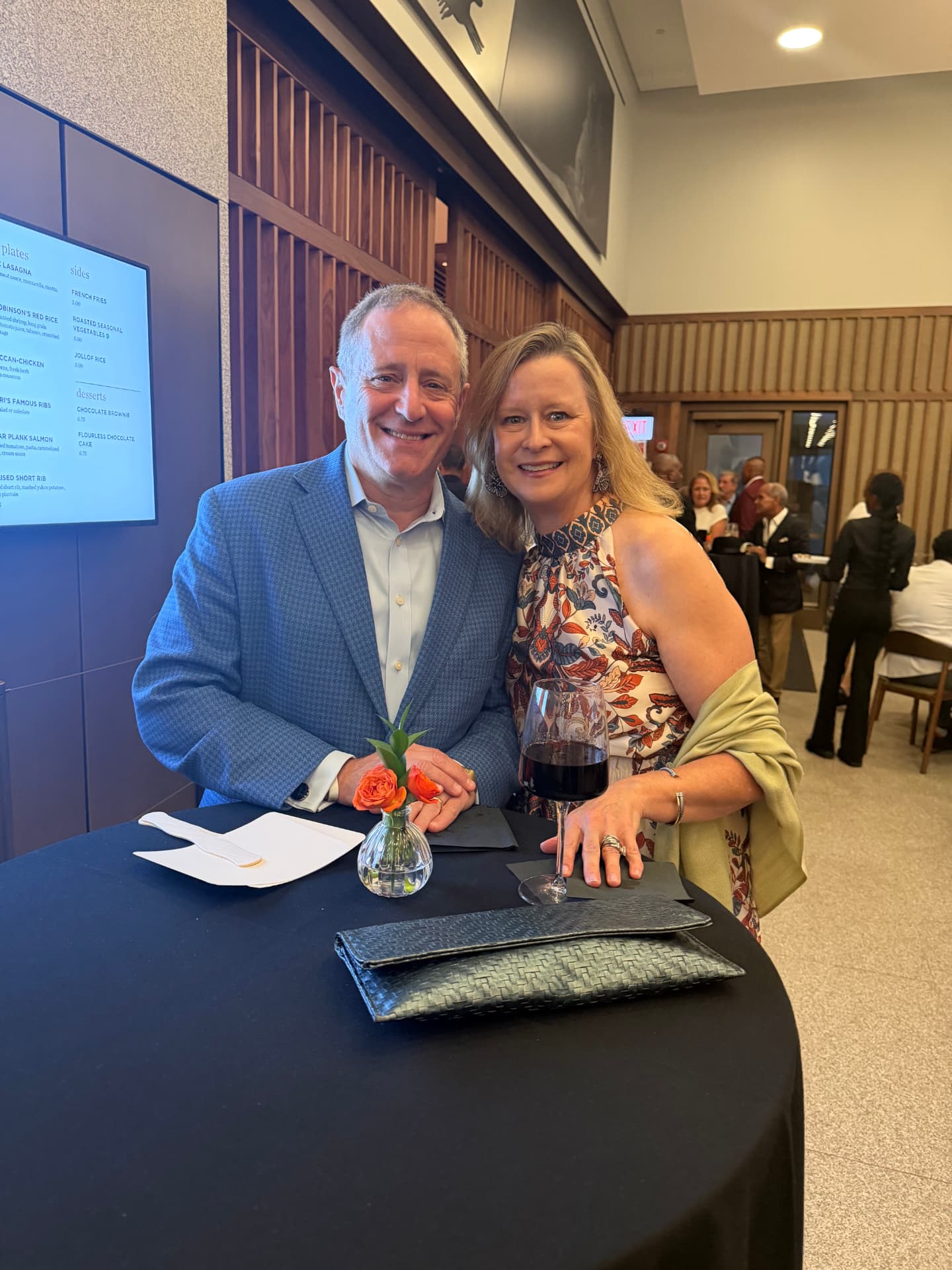 A couple smiling together at a cocktail table