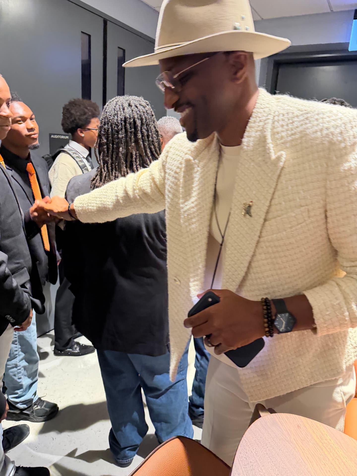 The guest artist shaking hands down a line of choir members
