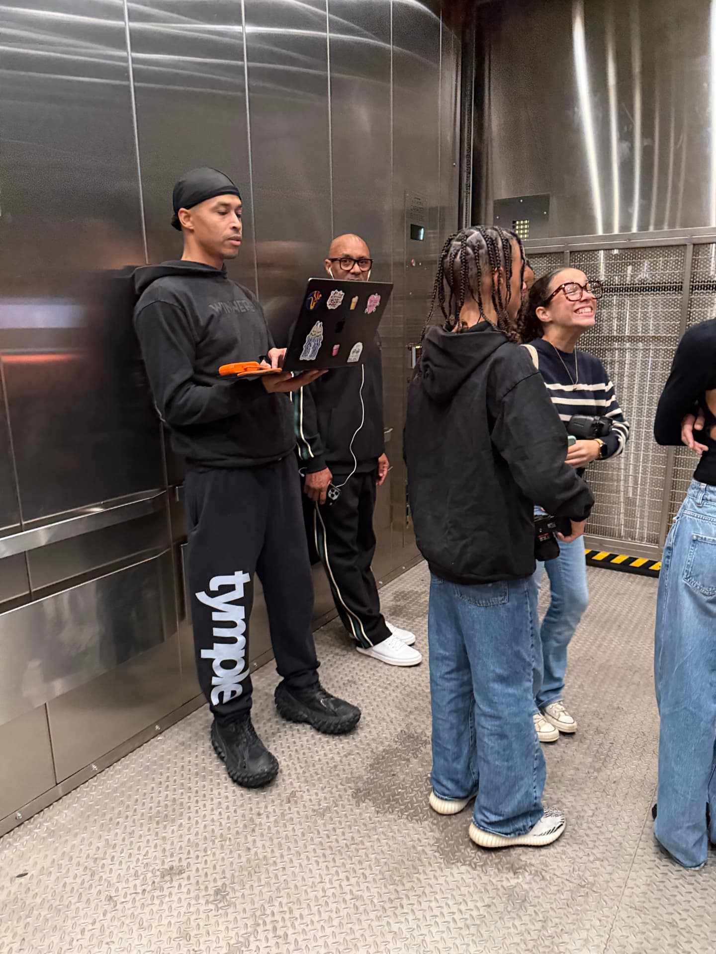 The production crew riding the freight elevator before the show