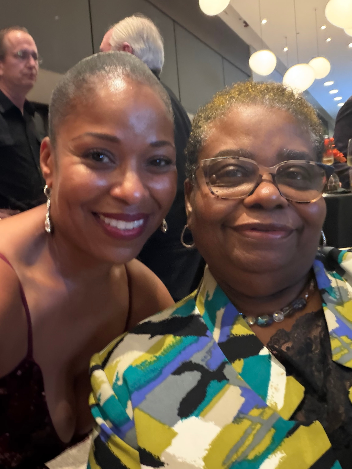 Two guests sharing a smiling selfie at their table