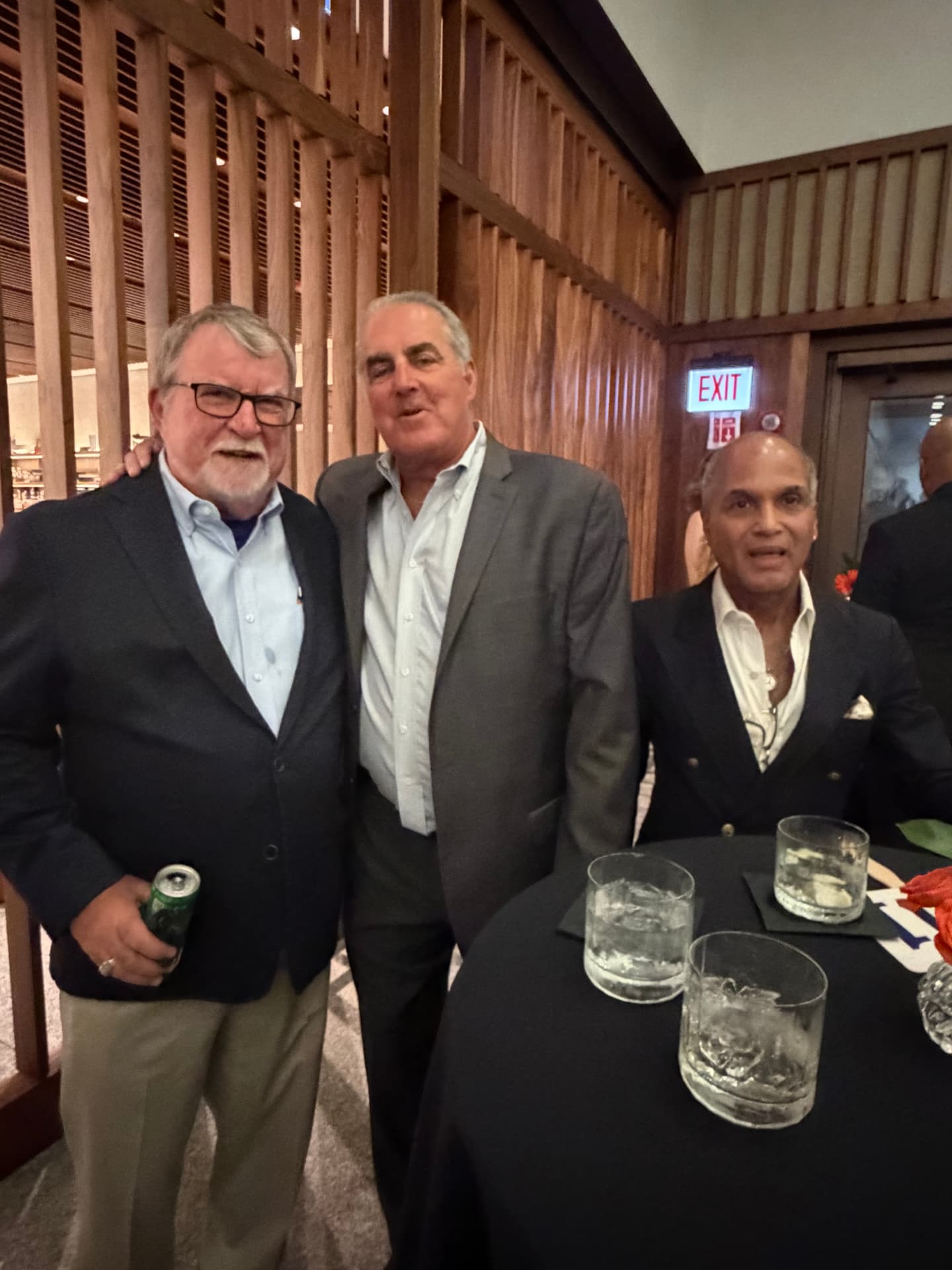Three alumni and supporters together at the reception