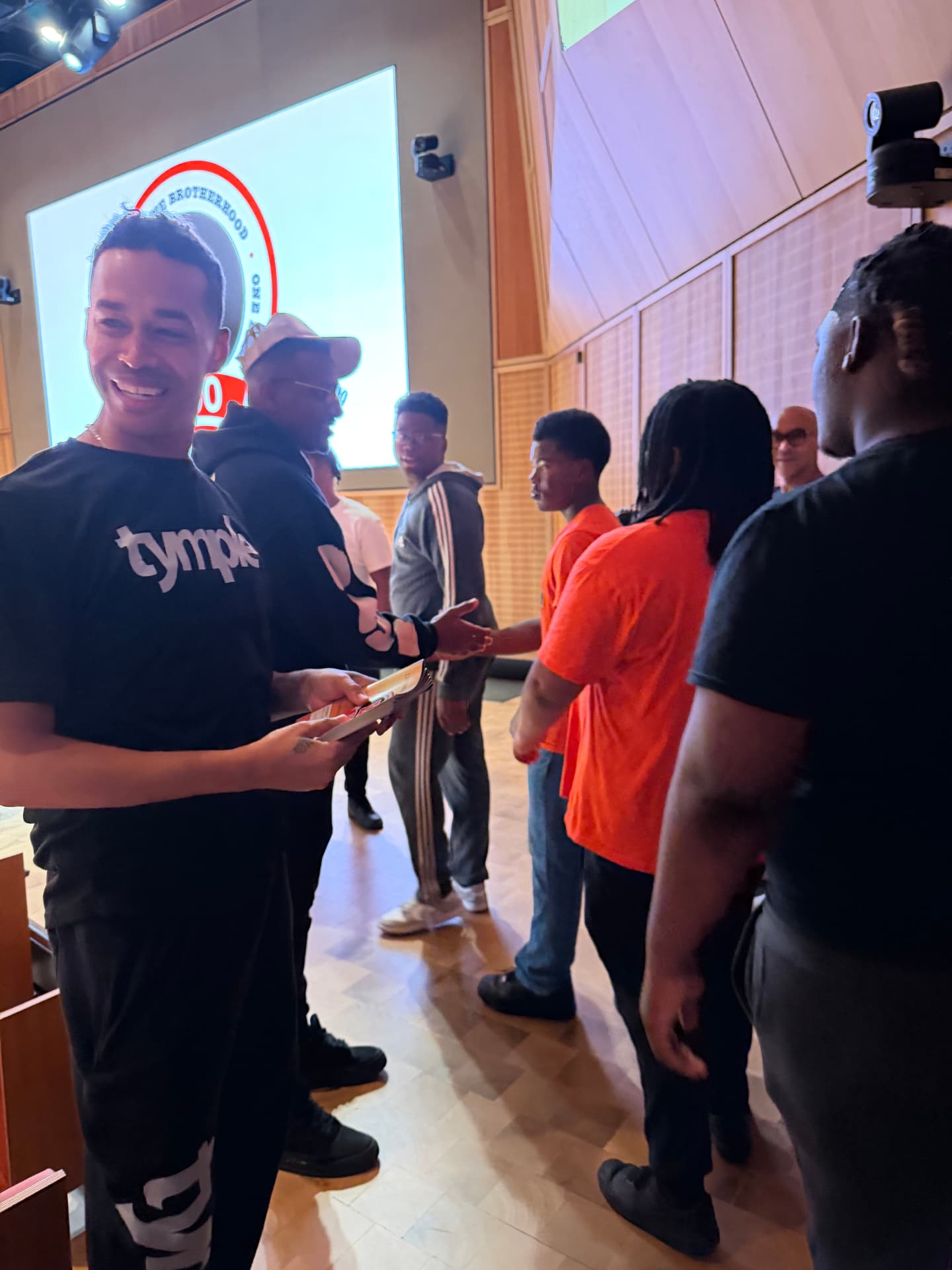 Guest artists greeting Leo students in the auditorium before the show