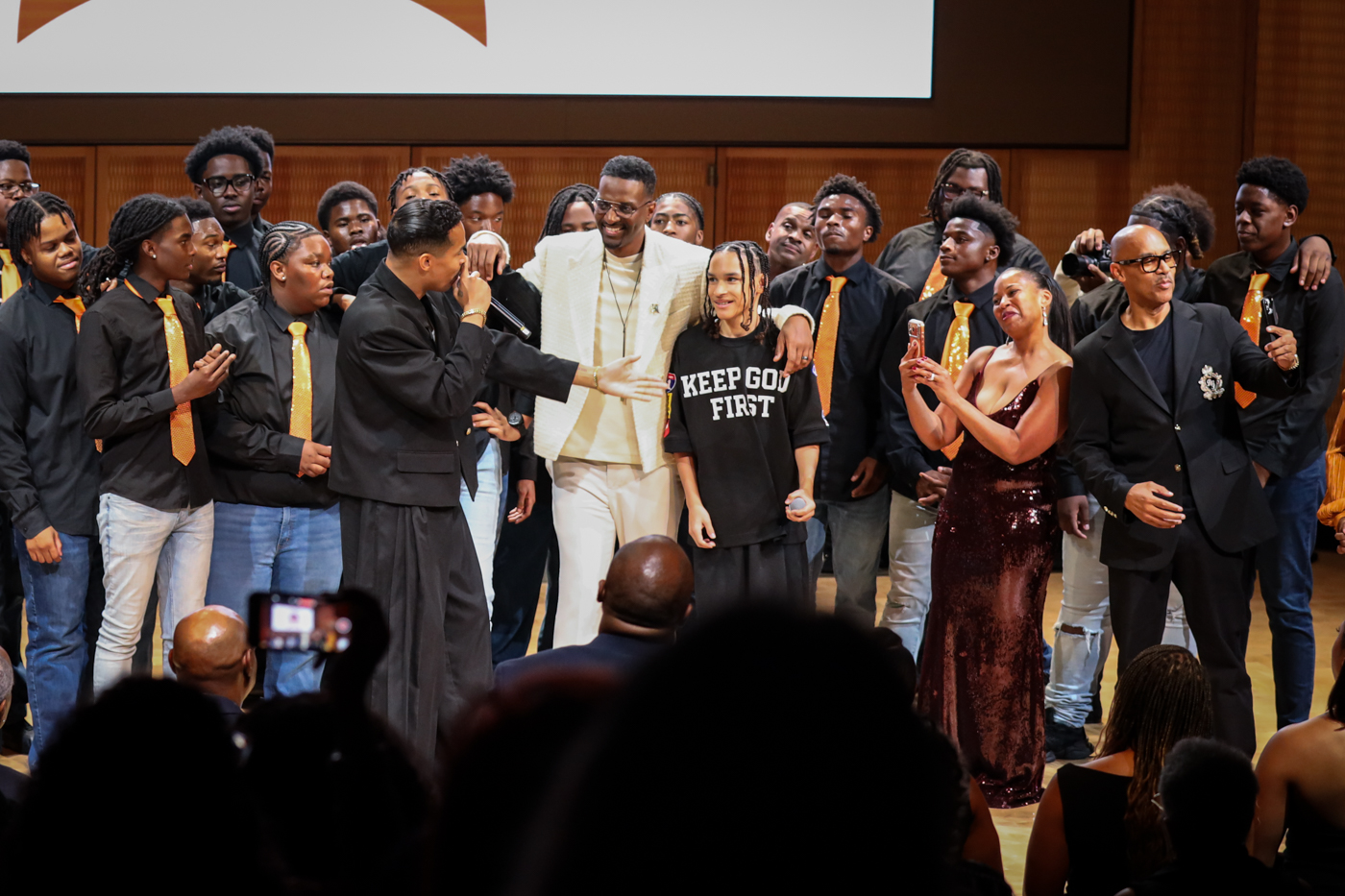 The full choir, guests, and supporters gathered together on stage