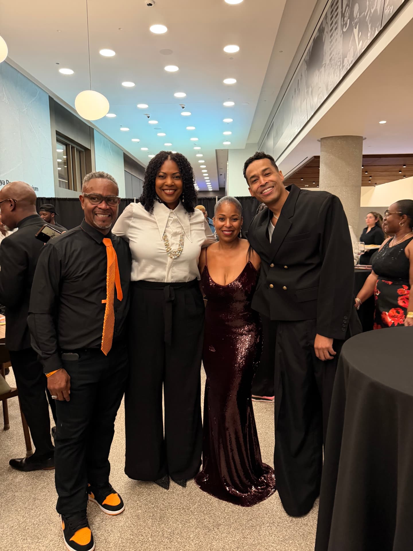 Four guests smiling together at the after-party reception